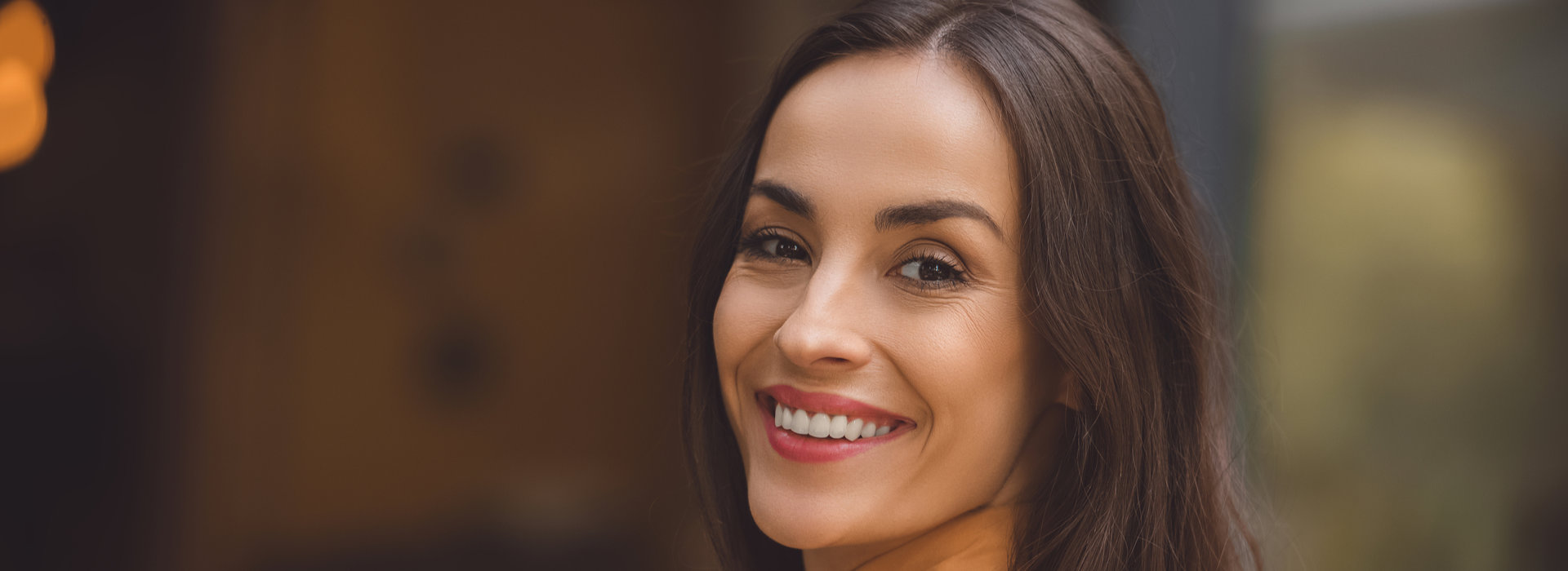 A beautiful woman is smiling after teeth whitening.