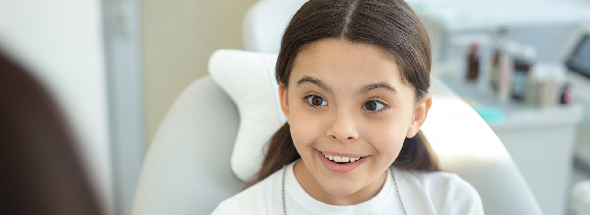 A child is smiling after receiving children's dentistry.
