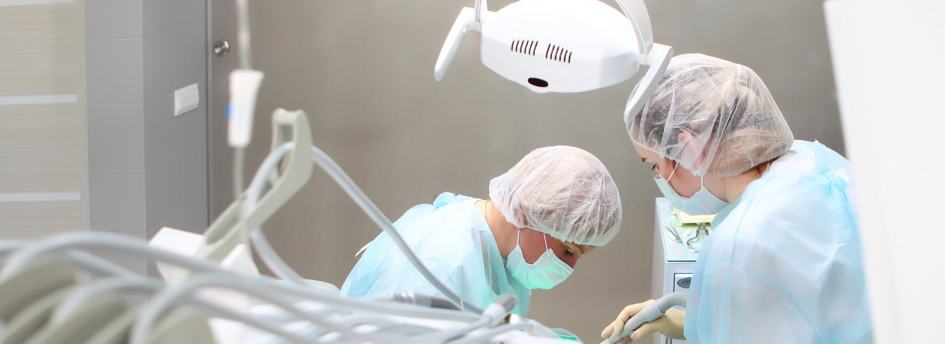 A dentist performing oral surgery on a patient.