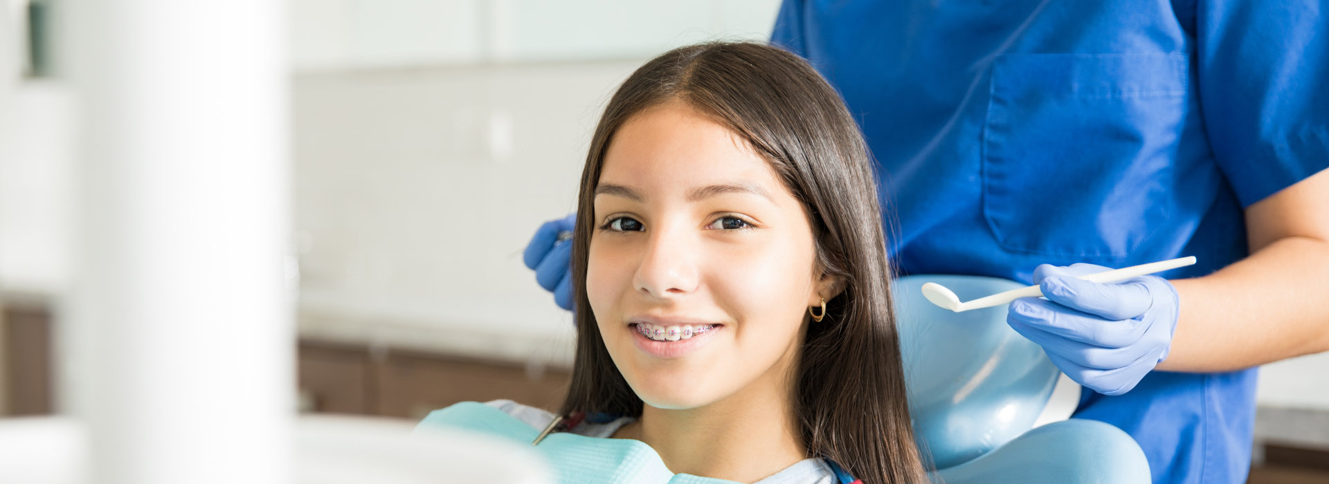 A beautiful woman is smiling after receiving ortho screenings.