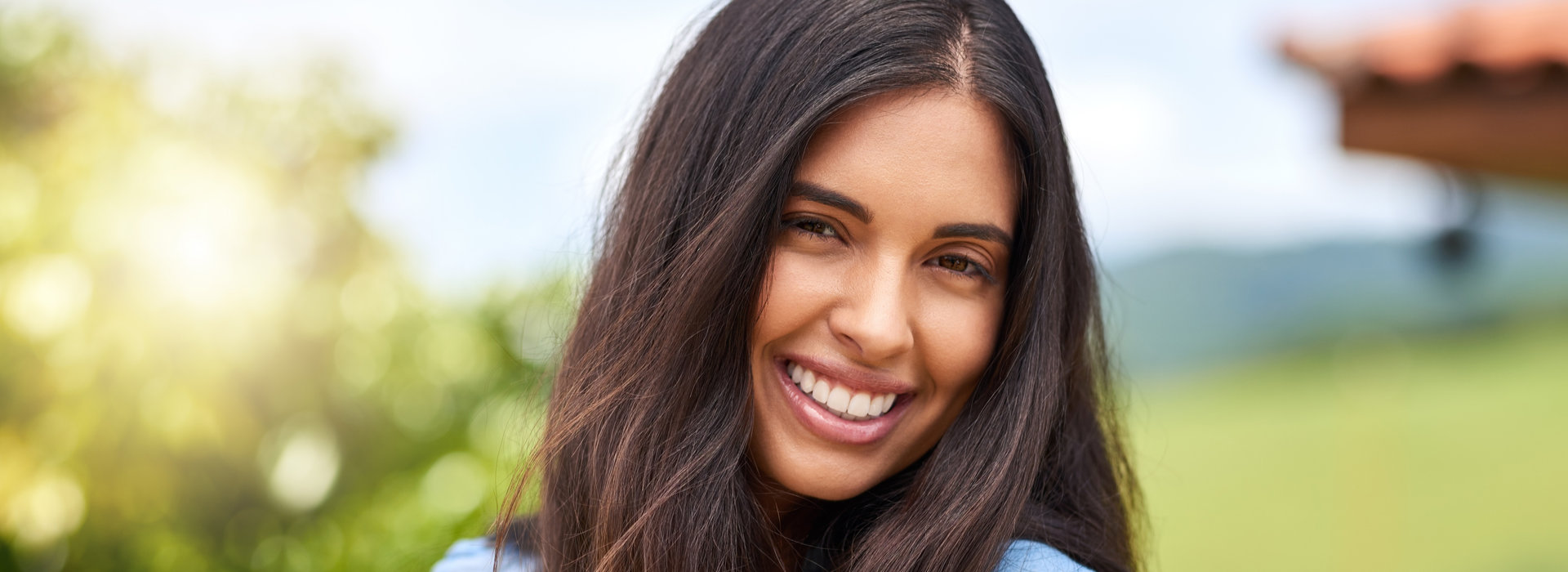 A beautiful woman is smiling after receiving dental sealants.