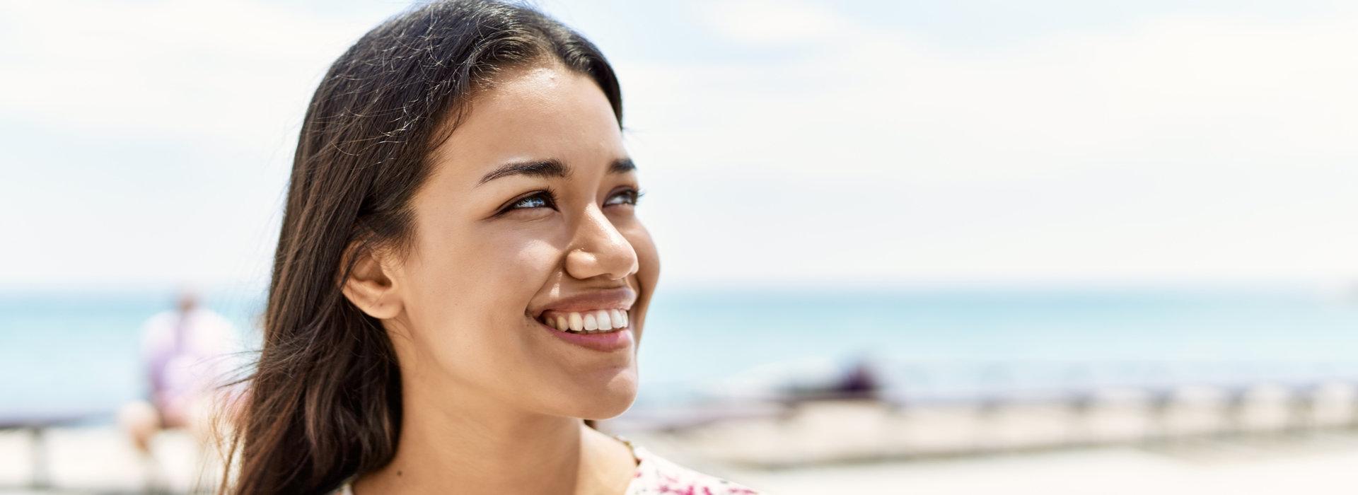 A woman is smiling after receiving gum contouring treatments.