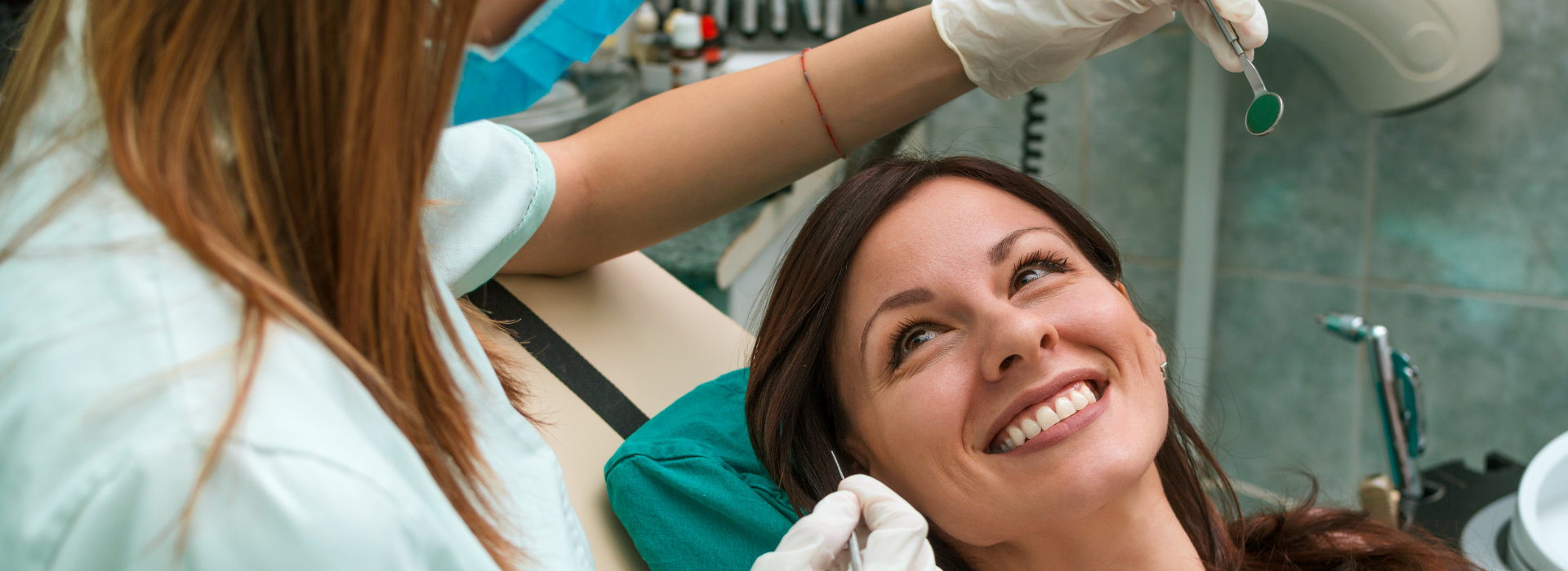 A woman is smiling after receiving extractions & preservation treatments.