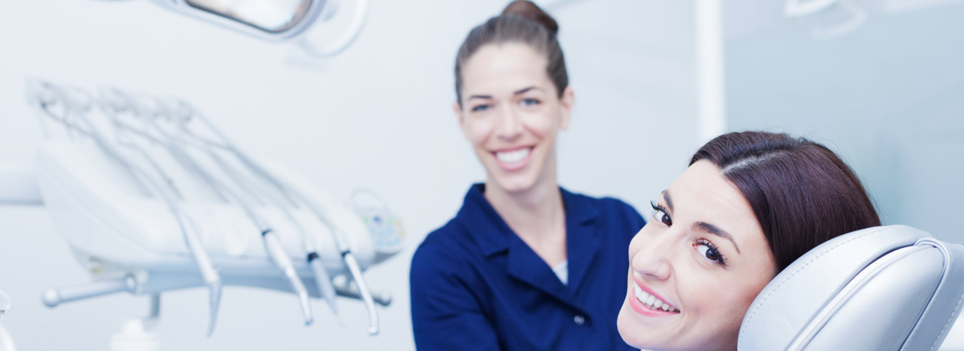 A woman and dentist smiling during a dental appointment.