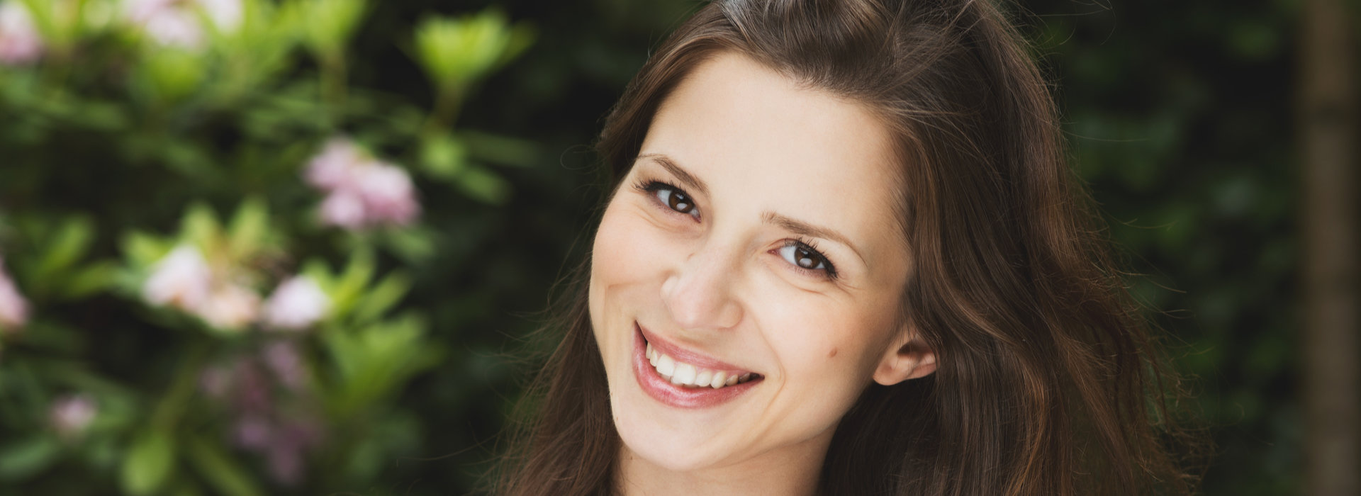 A beautiful woman is smiling.