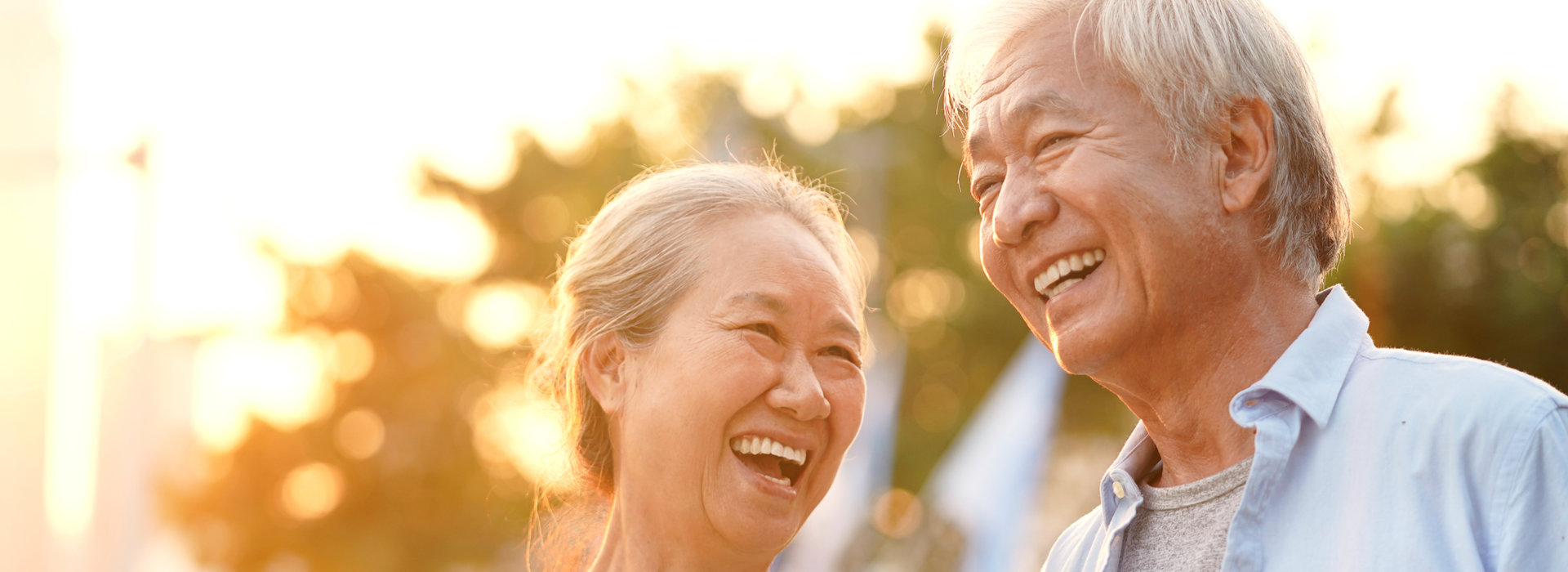 A couple is smiling after having tooth extractions.