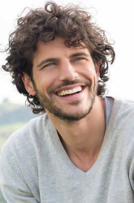 A man is smiling after root canals treatment.