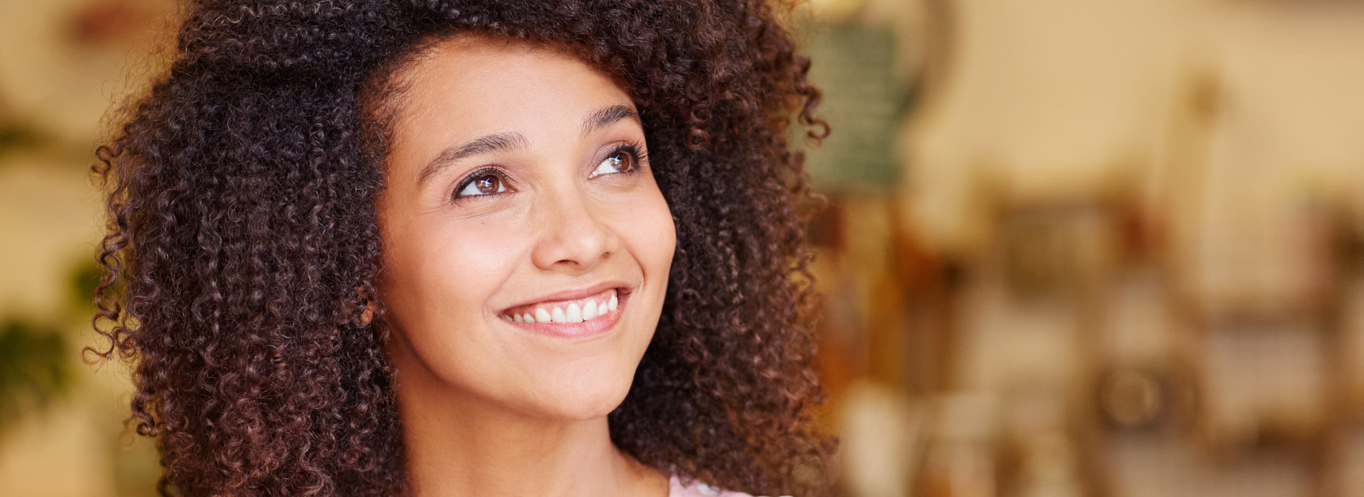 A beautiful woman is smiling after teeth cleaning.