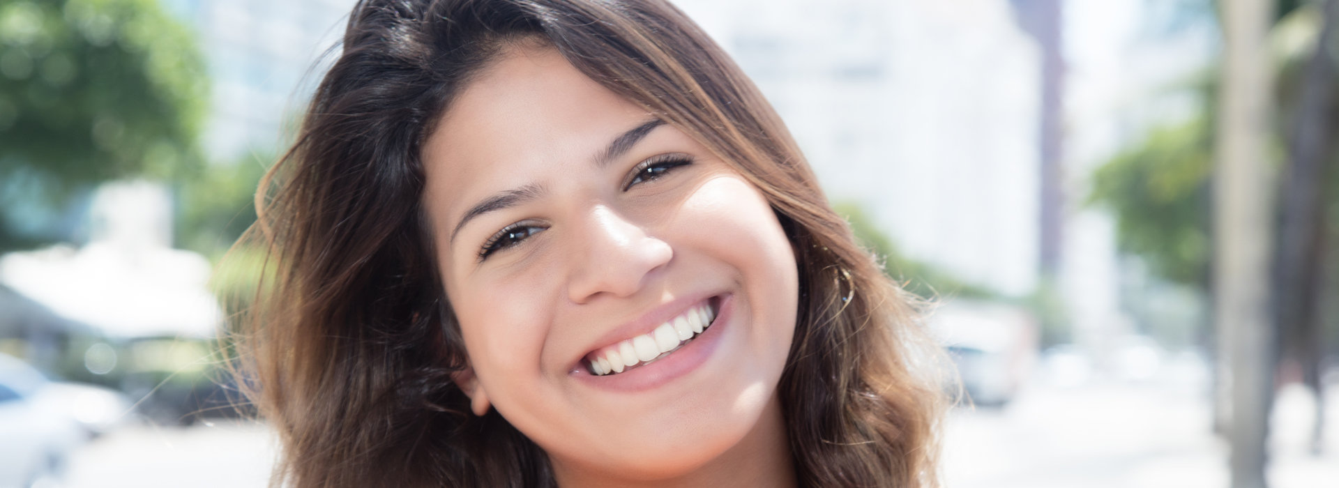 A woman is smiling after restorative dentistry.